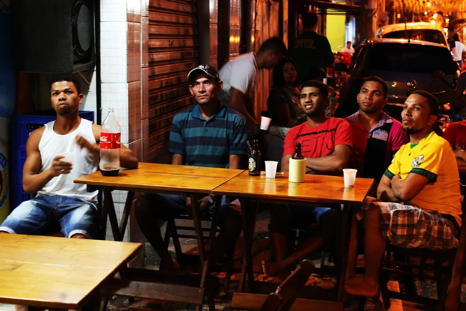 A few friends sit in a local bar to watch the game